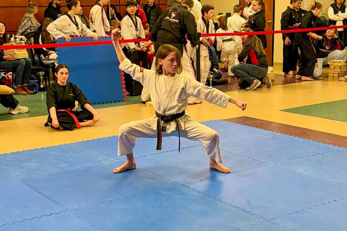 Competitor in a low stance performing an open form