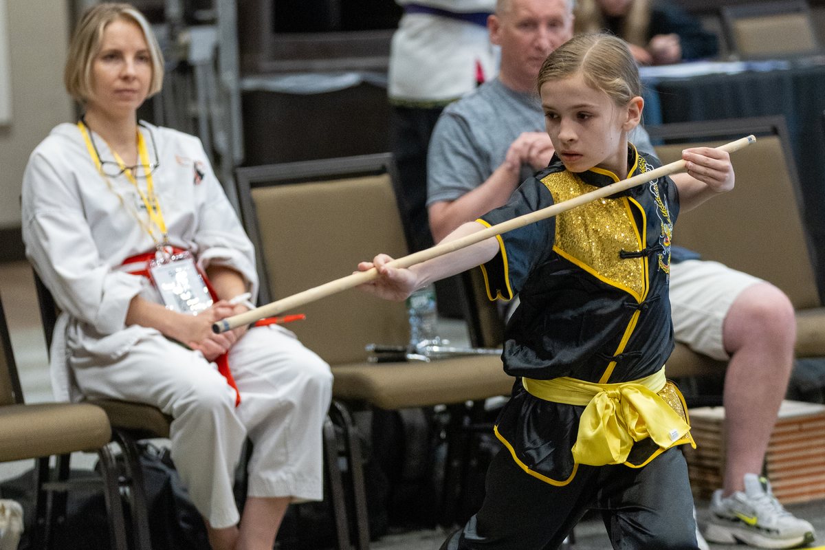Young competitor performing a traditional staff form
